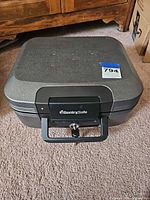 Closed SentrySafe chest front view showing handle, logo and key lock