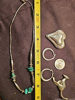 All items laid out beside ruler showing scale