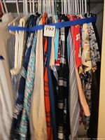 Clothing on hangers showing variety of prints and colours