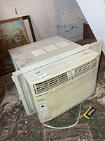 Front and side view of Kenmore window AC showing grille, control panel, side panels, power cord
