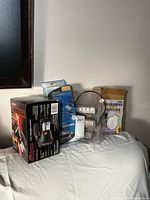 Group view of boxed spotlight, window film kit, driving lights, bulb pack