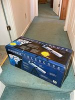 Sealed Bushnell telescope box on hallway floor