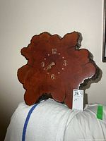 Front view of live edge wood clock showing numerals and hands