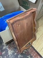 Wooden serving tray and part of blue dish visible in box
