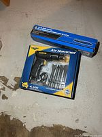Boxed Vaper air hammer kit and boxed 1/2 in. air ratchet on floor