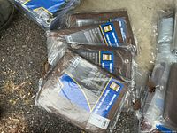 Sealed brown tarps showing size label 4' x 18' in packaging
