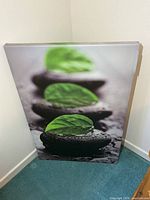Front view of full canvas leaning against wall