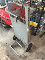 Front view of folded Ridgid MS-UV stand with wheels and handle visible