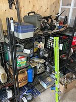 Full view of black metal wire shelving loaded with items