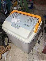 Full view of portable cooler showing body, lid, handle and power cord