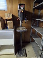Full view of floor drill press with base, column, table and head