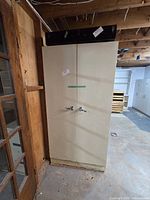 Full front view of tall metal cabinet closed