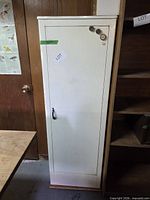 Full view of white metal single-door cabinet