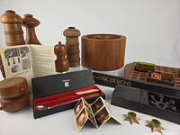Group shot of pepper mills, bar set in box, brochures, spider holder, starburst holders, tray with glass inserts, ice bucket partially visible