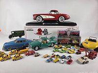 Group shot showing all vehicles including large Corvette, blue Schuco sedan, green Karmann-Ghia, yellow dune buggy and assorted miniatures