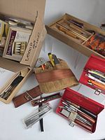 Overview of assorted carving tools, red toolboxes, roll pouch, boxed sets