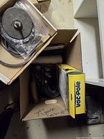Top view of box showing abrasive wheel, sanding belts, Vac-Pole box
