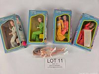 Group shot of four boxed dolls and one loose doll