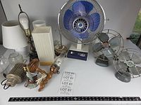 Group shot showing all three desk fans, multiple lamp bases, two fabric shades and glass chimneys