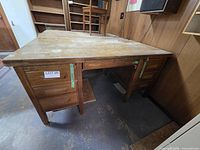 Front view of large wooden desk showing drawer pedestals and kneehole