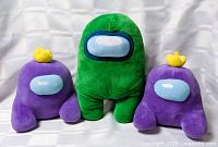 Front view of all three Among Us plush toys