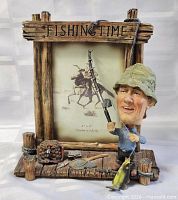 Front view of Fishing Time frame showing dock motif and fisherman figure