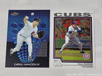 Front view of both Greg Maddux cards side by side