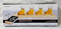 Retail box showing four skate shot glasses on hockey stick tray
