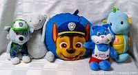 Group shot of all five plush items
