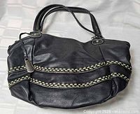 Front view of black Naturalizer handbag showing whipstitch trim and handles