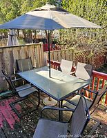 Full view of table, chairs, umbrella on deck