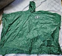 Full view of green hooded poncho spread out