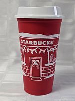 Front view of red Starbucks cup with lid