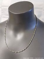 Full view of sterling chain on display bust