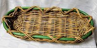 Top view of oval wicker basket showing weave and green rim