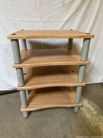 Front angled view showing four shelves and gray legs
