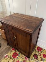 Full view of oak cabinet showing drawers and door