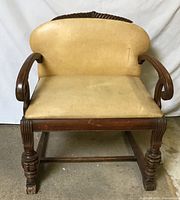 Front view of antique wood barrel-back chair with beige upholstery