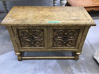 Full frontal view showing cabinet, carved doors, overall finish