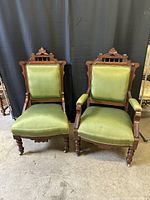 Front view of both chairs showing upholstery and carved frames