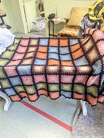Blanket draped over bench showing full pattern of squares