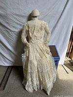 Full back view of ivory lace wedding dress on mannequin