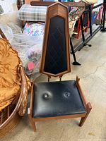 Front view showing high backrest, diamond-tufted vinyl panel and seat
