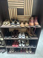 Full shelving unit showing over ten pairs of assorted men’s and women’s shoes