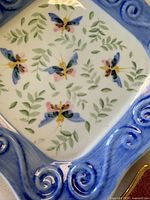Close-up of blue-rim square dish butterfly motif