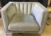 Front/angled view showing seat, channel-tufted back and overall condition