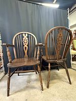 Both Windsor wheelback armchairs front view showing arms, seats, legs