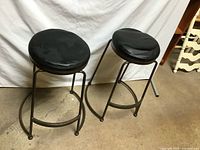 Both bar stools front view against backdrop