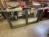 Pair of large gray wood-framed mirrors angled view