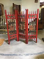 Full view of three-panel red wood folding screen